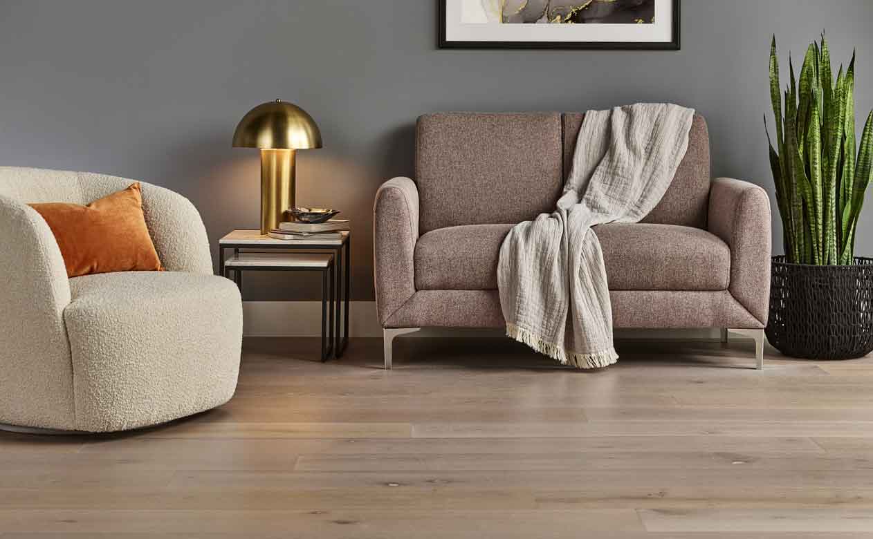 Hardwood flooring i nliving area with gray walls and cozy furniture