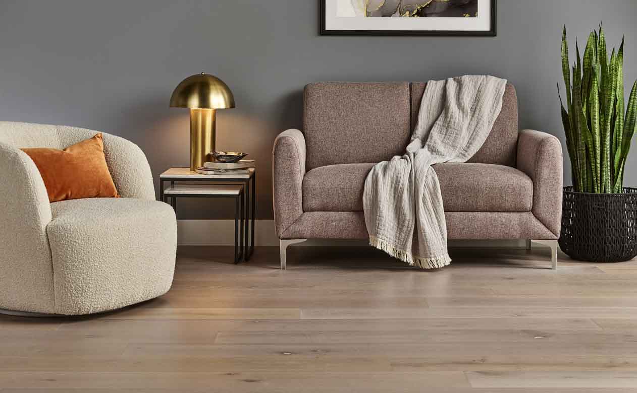 Hardwood flooring in living area with gray walls and cozy furniture